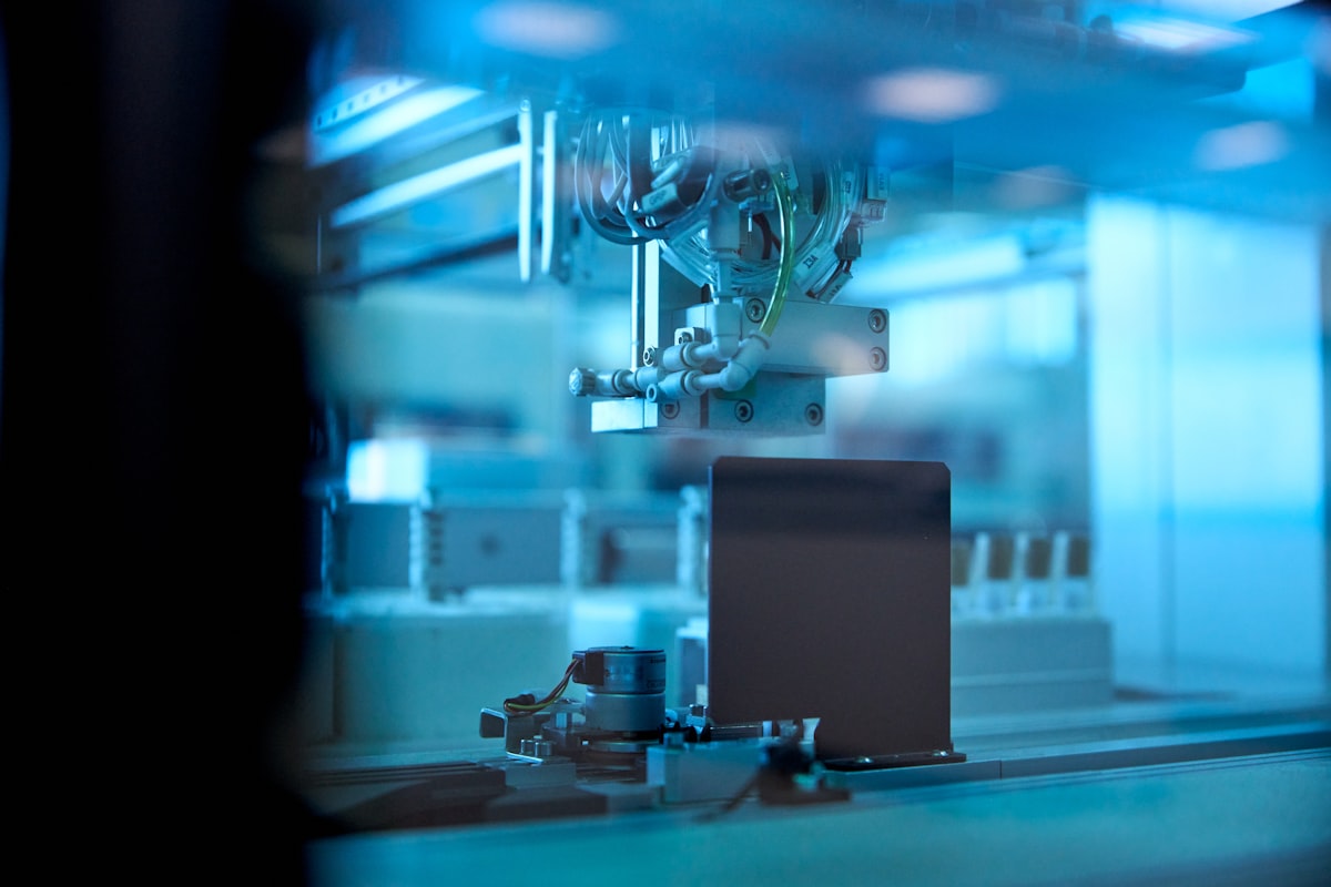 Automated laboratory equipment bathed in blue light